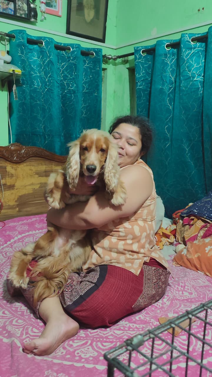 Pet parent hugging her Cocker Spaniel
